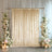Elegant beige velvet backdrop with floral arrangements and candles.