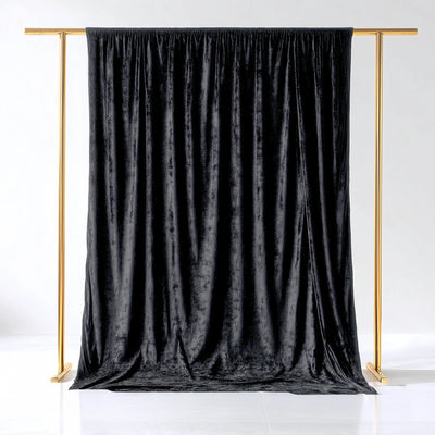 Black velvet backdrop on a gold stand for photography or events.