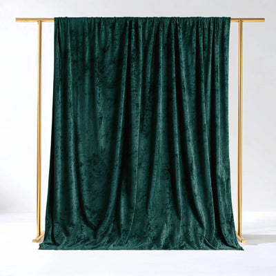 Emerald green velvet backdrop draped elegantly on a gold frame