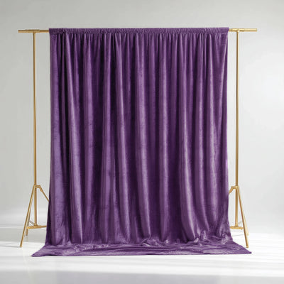 Purple velvet backdrop on a gold stand for photography staging
