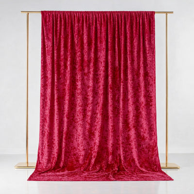 Red velvet backdrop hanging from a gold frame in a studio setting.