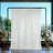 Elegant cream backdrop with floral arrangements in stylish vases.