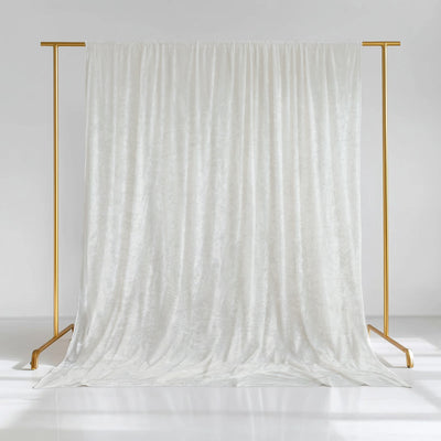 White velvet backdrop on a gold stand for photography.