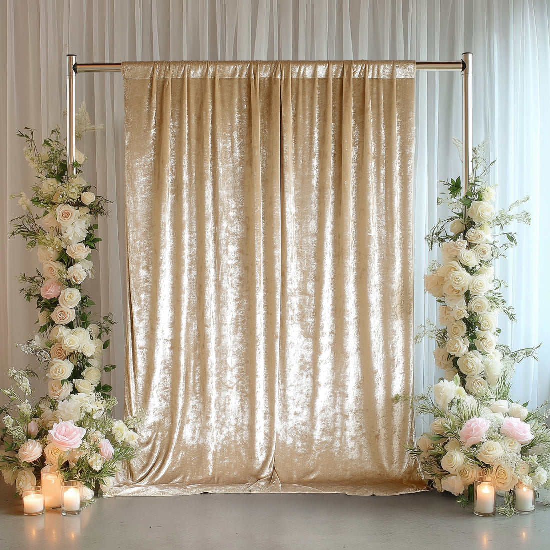 Elegant gold velvet backdrop with floral arrangements and candles.
