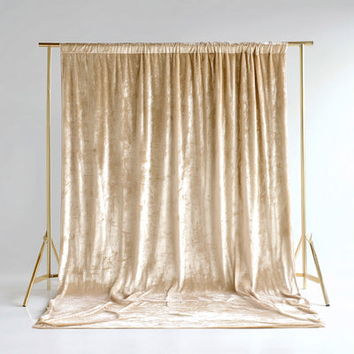 Gold velvet backdrop draped elegantly on a gold frame for photography displays.