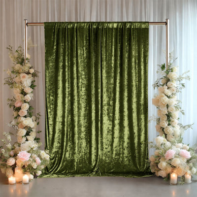 Green velvet wedding backdrop with floral arrangements and candles