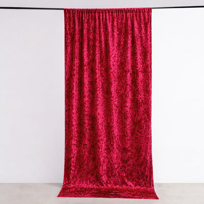 Bright red velvet fabric draping elegantly against a plain backdrop