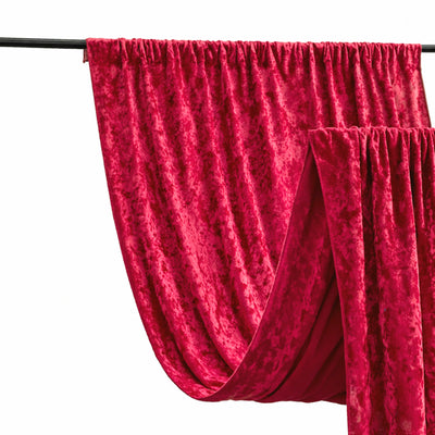 Red velvet drapes hanging stylishly on a curtain rod