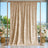 Elegant champagne gold backdrop curtain with floral arrangements and copper stand