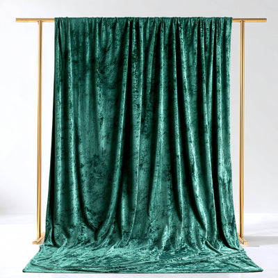 Green velvet backdrop draped elegantly on a gold frame.