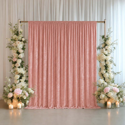 Pink wedding backdrop with floral pillars and candles