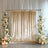 Elegant gold velvet backdrop with floral arrangements and candles for events.