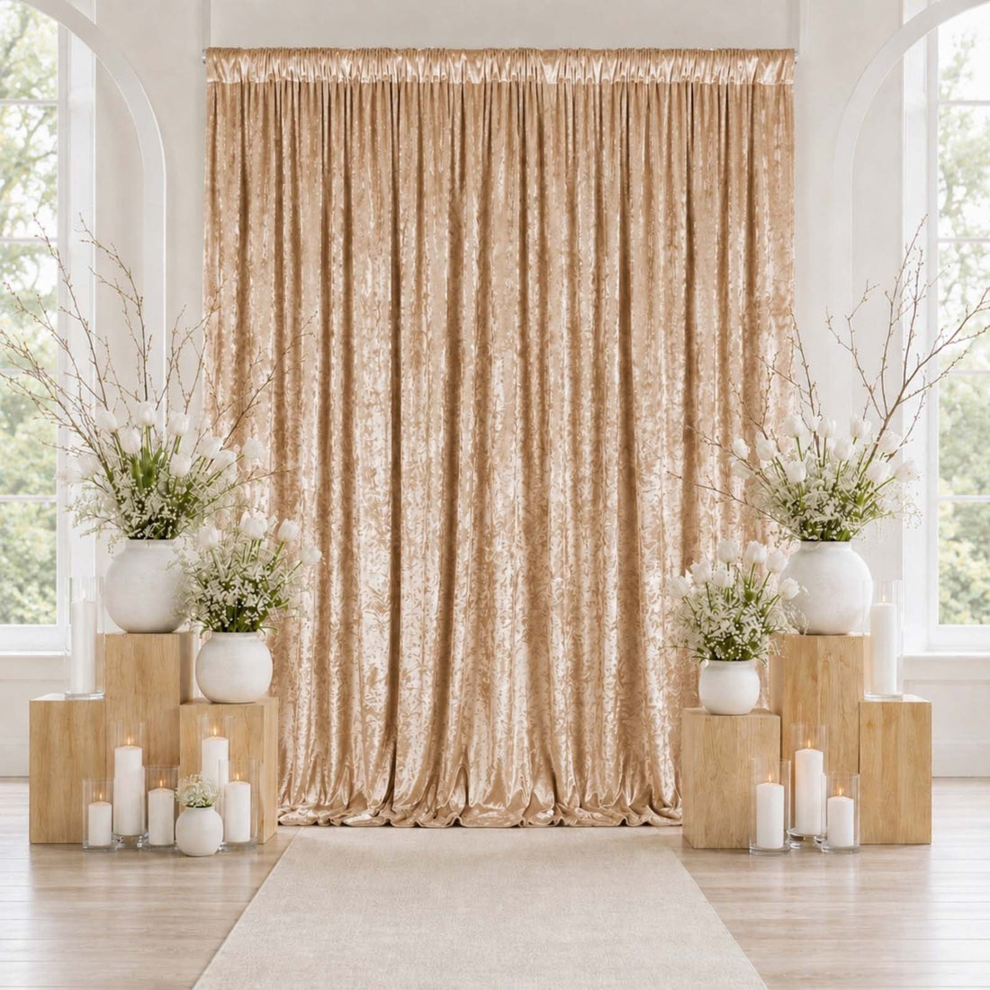 Elegant gold wedding backdrop with white floral arrangements and candles