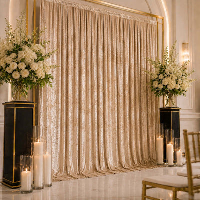 Elegant wedding ceremony backdrop with white floral arrangements and candle decor