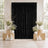 Elegant black backdrop with white floral arrangements and candles at a wedding ceremony.