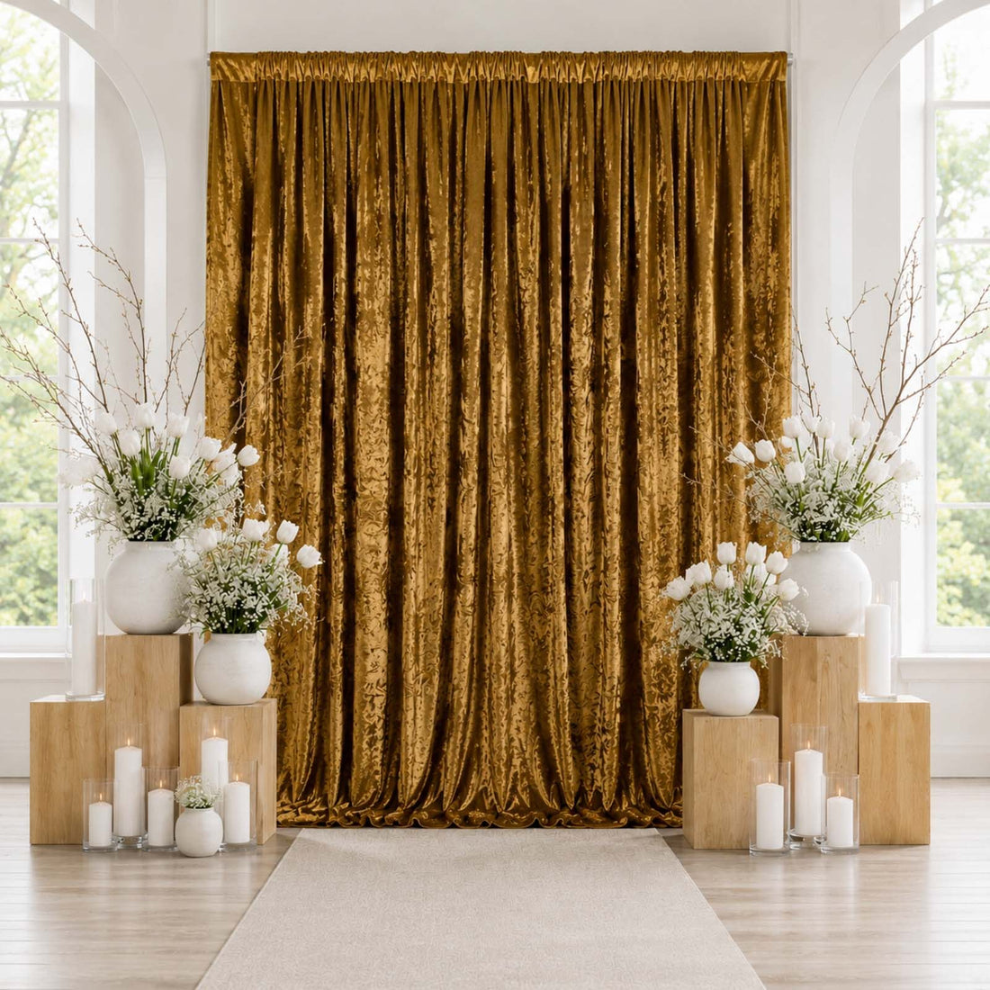 Elegant gold velvet curtain backdrop with white floral arrangements and candles