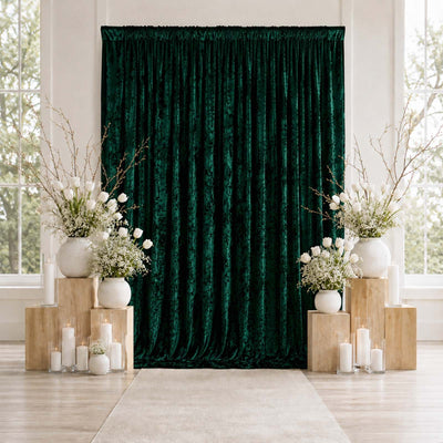Emerald velvet backdrop with white floral wedding decor and candles