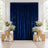 Elegant navy blue velvet curtain backdrop with white floral and candle decor
