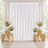 Elegant white wedding backdrop with floral arrangements and candles