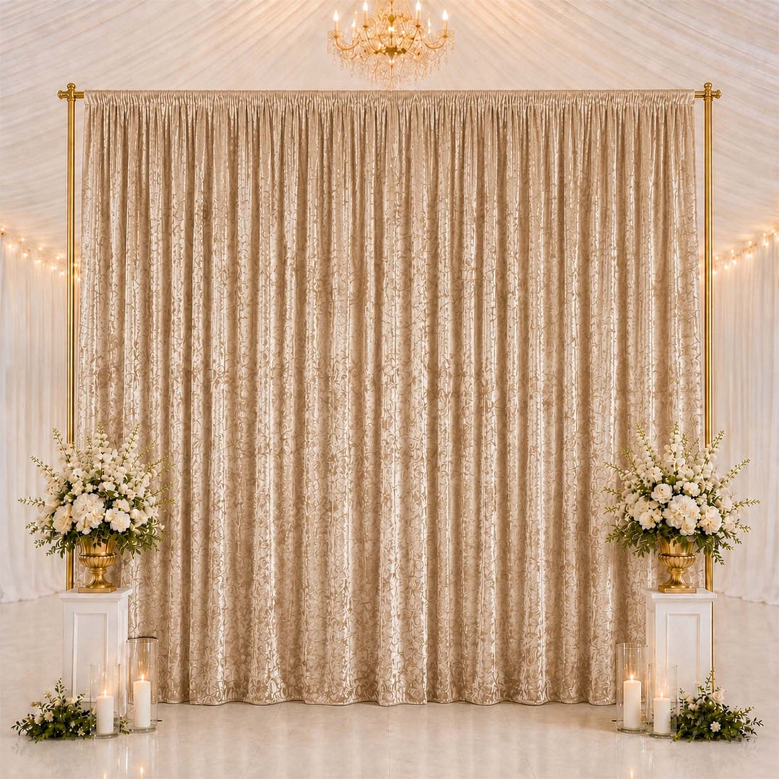 Elegant gold wedding backdrop with curtains, floral arrangements, and candles