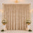 Elegant gold wedding backdrop with curtains, floral arrangements, and candles