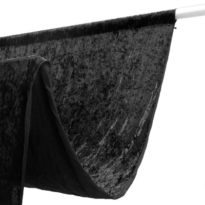 Black velvet curtain panel hanging on a silver rod
