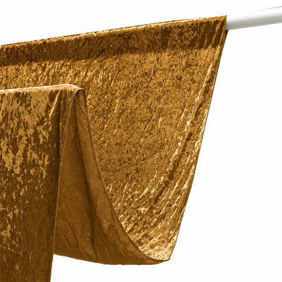 Gold velvet drape hanging on a white curtain rod
