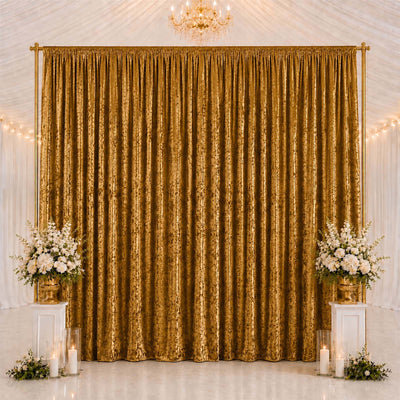 Gold wedding backdrop curtain with floral arrangements and candles