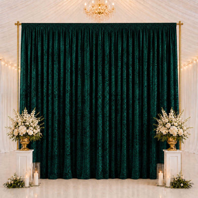 Elegant emerald green velvet backdrop with gold frame and floral decor