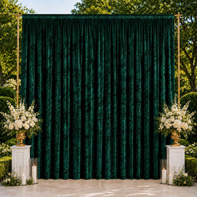 Emerald green wedding backdrop with floral arrangements and candles