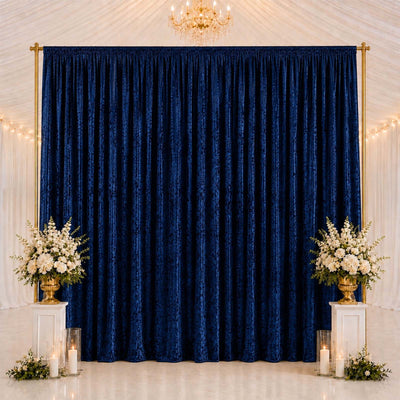 Elegant navy blue curtain backdrop with floral arrangements and gold accents