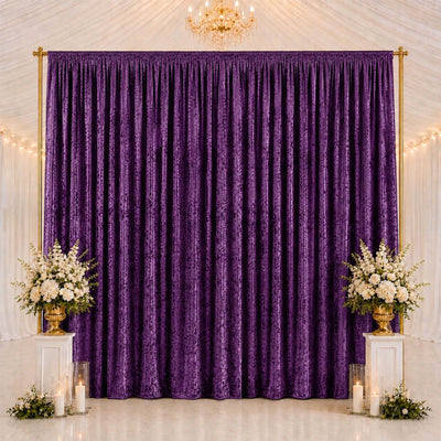 Elegant purple backdrop curtain with floral arrangements and candles