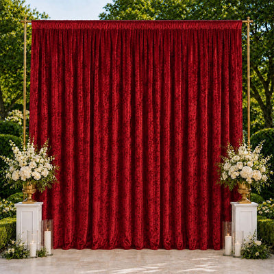 Elegant red velvet backdrop with white floral arrangements and candles