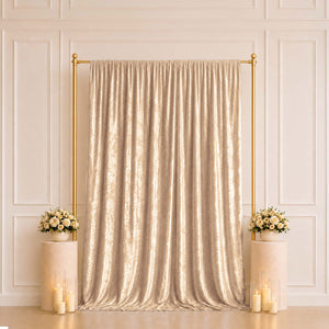 Gold shimmer curtain backdrop with floral pedestals and candles