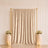 Gold shimmer curtain backdrop with floral pedestals and candles