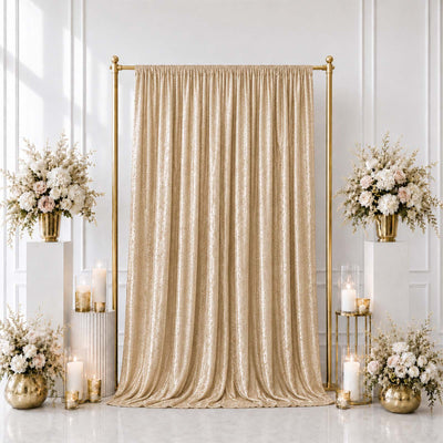 Elegant gold wedding backdrop with champagne drape and floral arrangements