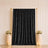 Black velvet curtain backdrop with gold frame and floral pedestal decor