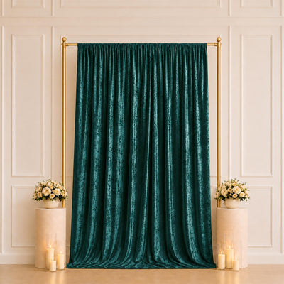Emerald velvet curtain backdrop with gold frame and floral arrangements