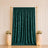 Emerald velvet curtain backdrop with gold frame and floral arrangements