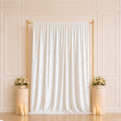 Elegant wedding backdrop with white drape, gold frame, roses, and candles