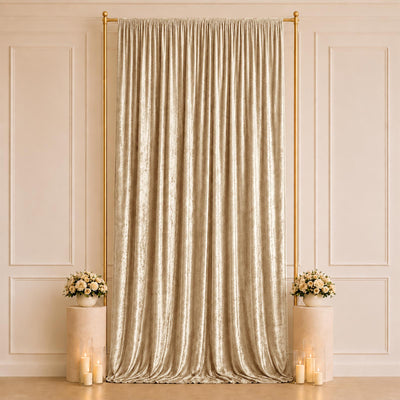 Elegant gold draped backdrop with floral pedestals and candles