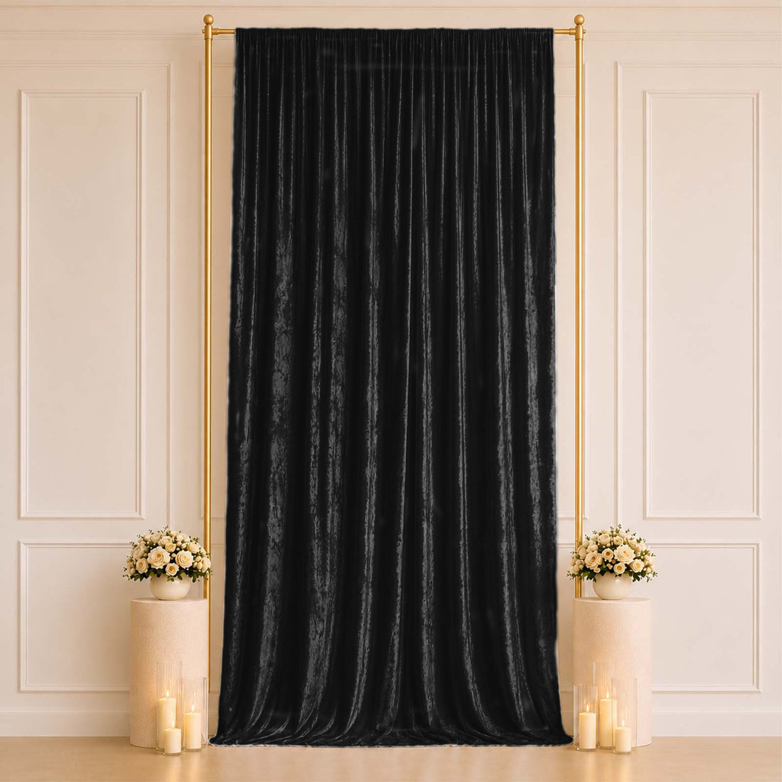 Black velvet draped backdrop with gold frame, floral pedestals and candles