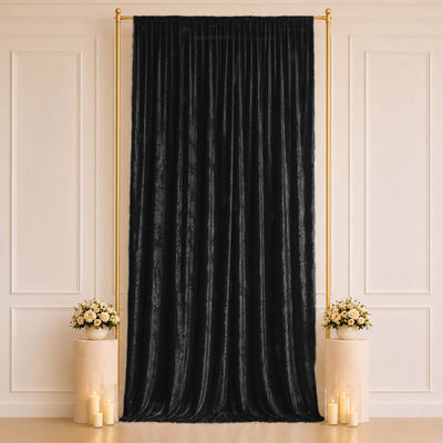 Black velvet draped backdrop with gold frame, floral pedestals and candles