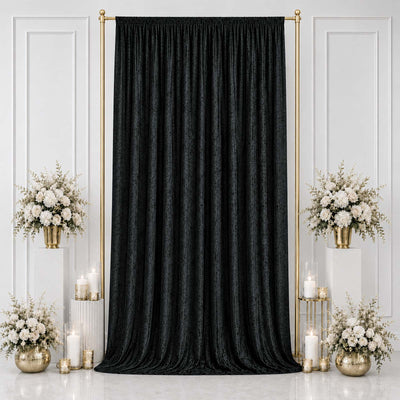 Elegant black textured curtain backdrop with gold floral decor and candles