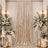 Elegant wedding backdrop with champagne velvet drape, white florals, and candles