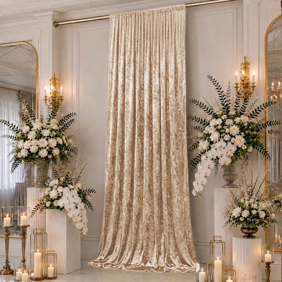 Elegant cream velvet curtain with white floral arrangements and candles in a luxury room