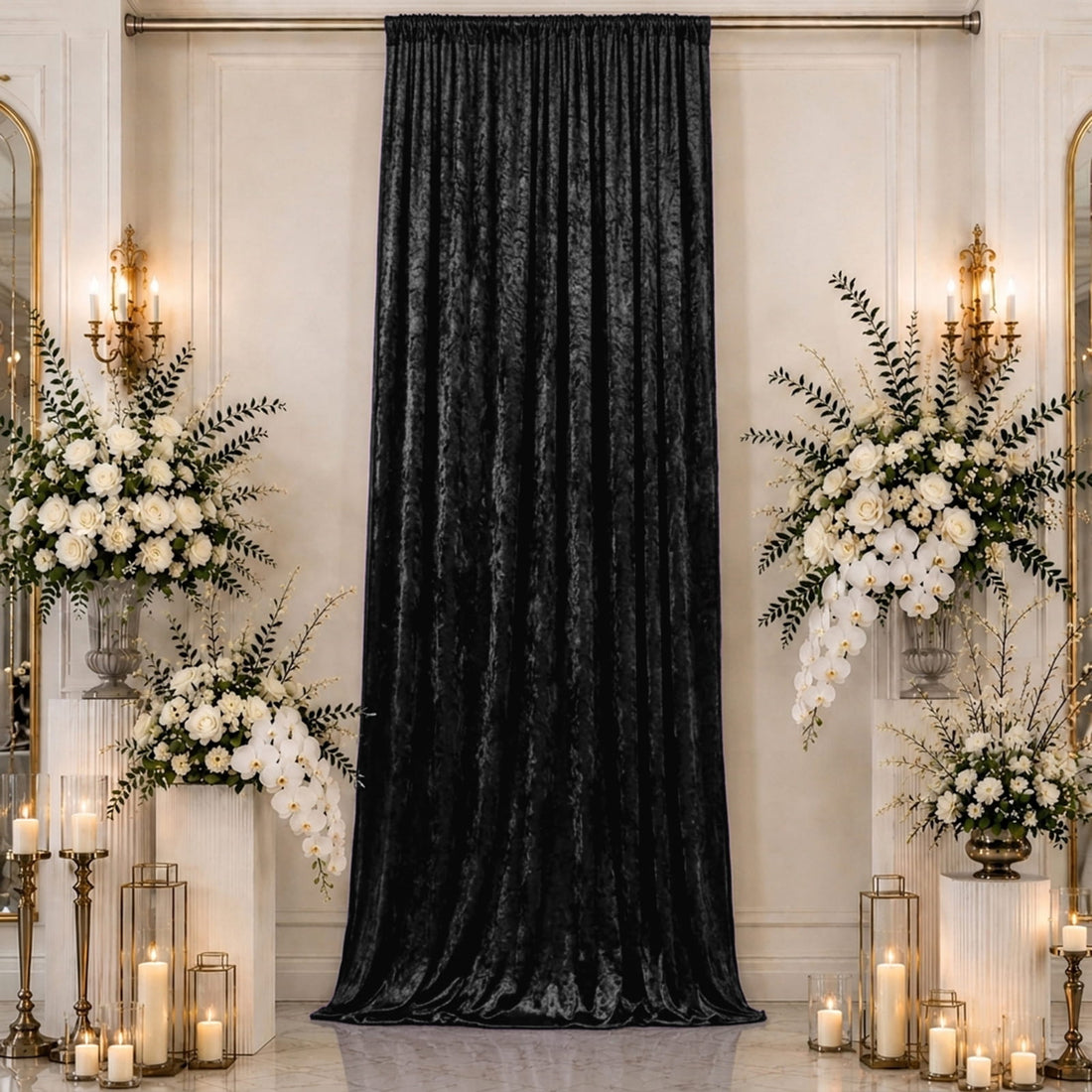 Elegant black velvet curtain with white floral wedding ceremony decor and candles