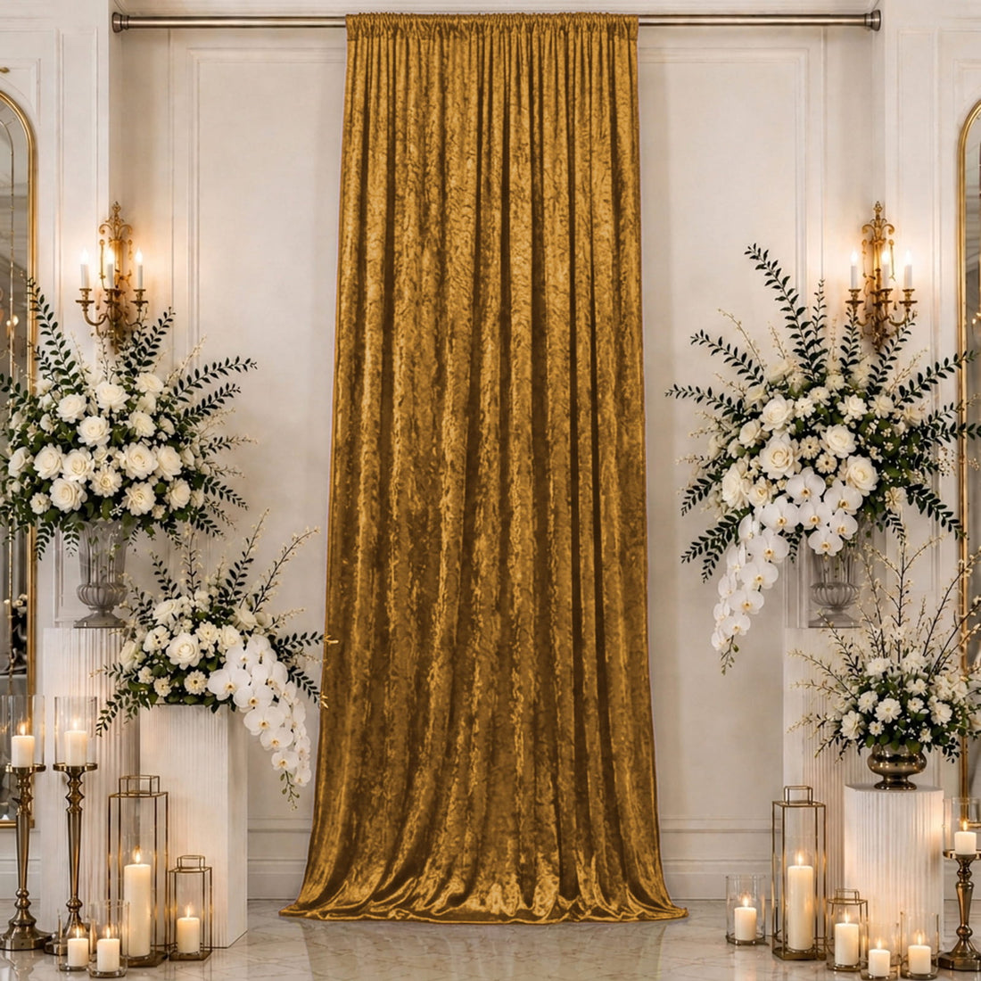 Elegant gold velvet curtain with white floral wedding decor and candles