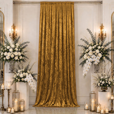 Elegant gold velvet curtain with white floral wedding decor and candles