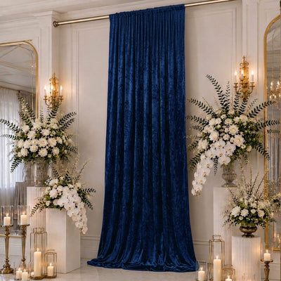 Elegant blue velvet backdrop with white floral arrangements and candles
